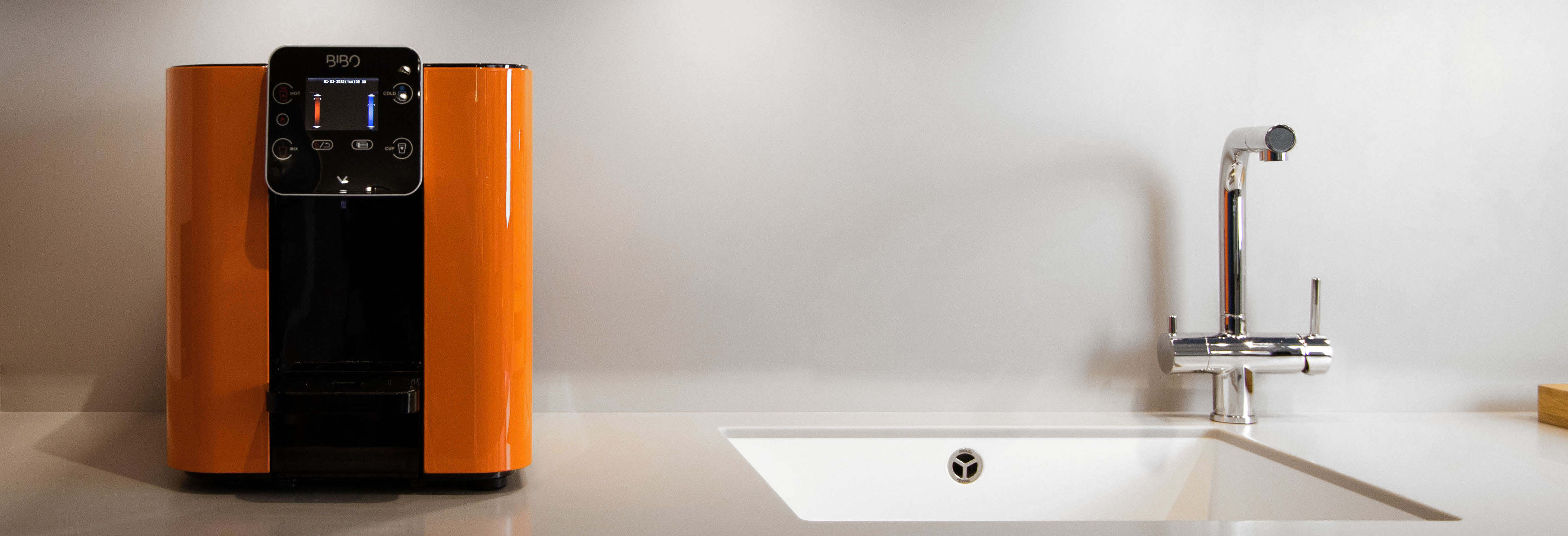 Orange BIBO water dispenser on a kitchen countertop